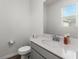 Clean bathroom with single vanity, toilet and mirror at 2559 Relaxing Ln, Kissimmee, FL 34747