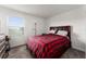 Bedroom with a red plaid comforter and window at 2559 Relaxing Ln, Kissimmee, FL 34747