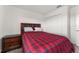Bedroom with red plaid comforter and double doors at 2559 Relaxing Ln, Kissimmee, FL 34747