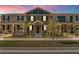 Two-story townhome with a charming front porch and landscaping at 2559 Relaxing Ln, Kissimmee, FL 34747