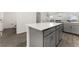 Gray kitchen island with white quartz countertop at 2559 Relaxing Ln, Kissimmee, FL 34747
