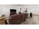 Living room with brown leather reclining sofas and a large TV at 2559 Relaxing Ln, Kissimmee, FL 34747