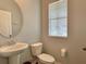Small half bathroom with pedestal sink and toilet at 2646 River Landing Dr, Sanford, FL 32771