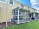 Back exterior view showing a screened patio and lawn at 2646 River Landing Dr, Sanford, FL 32771