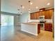 Open kitchen with island, stainless steel appliances, and wood cabinets at 2646 River Landing Dr, Sanford, FL 32771
