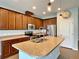 Kitchen with island, stainless steel appliances, and wood cabinets at 2646 River Landing Dr, Sanford, FL 32771