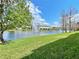 Serene view of a lake with lush landscaping at 2646 River Landing Dr, Sanford, FL 32771