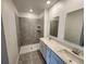 Bathroom with double sink vanity, walk-in shower, and modern tile at 2713 Runners Cir, Clermont, FL 34714