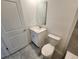 Bathroom featuring a toilet, vanity, and sink with modern fixtures at 2713 Runners Cir, Clermont, FL 34714