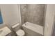 Well-lit bathroom features a shower over tub and a modern toilet at 2713 Runners Cir, Clermont, FL 34714