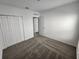 Bedroom with carpet and white walls, featuring double door closet at 2713 Runners Cir, Clermont, FL 34714
