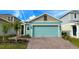 Charming, single-story home with a well-maintained front yard and a blue garage door at 2713 Runners Cir, Clermont, FL 34714