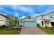 Single-story home with blue garage door, a paved driveway, and well-kept landscaping at 2713 Runners Cir, Clermont, FL 34714