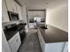 Contemporary kitchen featuring white cabinets, stainless steel appliances, and an island with a gray countertop at 2713 Runners Cir, Clermont, FL 34714