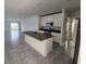 Open-concept kitchen features an island, stainless steel appliances, and stylish gray tile flooring at 2713 Runners Cir, Clermont, FL 34714