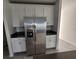 Kitchen showcasing stainless steel refrigerator and white cabinets at 2713 Runners Cir, Clermont, FL 34714