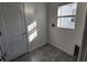 A compact laundry room featuring a window for natural light and necessary connections at 2713 Runners Cir, Clermont, FL 34714