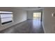 Spacious living room with tile flooring and sliding glass doors to the backyard at 2713 Runners Cir, Clermont, FL 34714