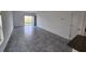 Bright, open living room with tile floors and sliding glass doors leading to the outdoor space at 2713 Runners Cir, Clermont, FL 34714