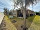 Backyard features a covered patio with furniture, a grill, and well-kept grass at 2931 Top Water Way, Kissimmee, FL 34746