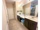 Bathroom with dual sinks, granite countertops, and a shower at 2931 Top Water Way, Kissimmee, FL 34746