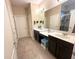 The bathroom features double sinks and a walk-in shower with a glass door at 2931 Top Water Way, Kissimmee, FL 34746
