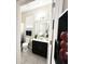 This well-lit bathroom boasts a dark vanity, white counter, and shower with an attractive blue curtain at 2931 Top Water Way, Kissimmee, FL 34746