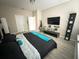 The main bedroom has light-colored walls and flooring with a large entertainment center at 2931 Top Water Way, Kissimmee, FL 34746