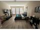 Spacious bedroom features laminate floors, ample light and large screen TV at 2931 Top Water Way, Kissimmee, FL 34746