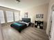 Bedroom with light, wooden flooring, a queen-sized bed, and modern decorations at 2931 Top Water Way, Kissimmee, FL 34746