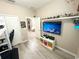 Bedroom with a tv, wooden flooring, and a shelf containing collectible action figures at 2931 Top Water Way, Kissimmee, FL 34746