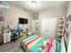 Cozy bedroom with colorful bedding, a tv, shelves with toys, and light-up decor at 2931 Top Water Way, Kissimmee, FL 34746