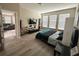Light filled primary bedroom has laminate floors and en suite bathroom at 2931 Top Water Way, Kissimmee, FL 34746