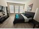 Bedroom with a black bed, sleek furniture, and natural light from the windows at 2931 Top Water Way, Kissimmee, FL 34746