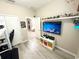 Bedroom with a large TV, decorative shelves, and laminate flooring creates a stylish and comfortable space at 2931 Top Water Way, Kissimmee, FL 34746