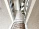 This entryway features gray tile floors, a welcome mat, modern decor, and access to other rooms in the house at 2931 Top Water Way, Kissimmee, FL 34746