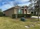 Well-maintained yard and lawn of single Gathering house, with beautiful green shutters and stone entryway at 2931 Top Water Way, Kissimmee, FL 34746