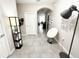 Contemporary foyer featuring stylish lighting, decorative wall art, and gray tile flooring at 2931 Top Water Way, Kissimmee, FL 34746