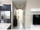 Inviting hallway with tile flooring leading to the front door and showcasing modern decor and neutral tones at 2931 Top Water Way, Kissimmee, FL 34746