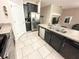 Modern kitchen featuring stainless steel appliances, dark cabinets and a light backsplash at 2931 Top Water Way, Kissimmee, FL 34746