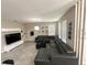 Expansive living area showcasing tile floors, a comfortable sectional sofa, and a stylish entertainment setup at 2931 Top Water Way, Kissimmee, FL 34746