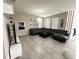 Spacious living room featuring a large sectional sofa, modern lighting, and a sleek entertainment center at 2931 Top Water Way, Kissimmee, FL 34746