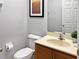 Small bathroom with toilet, sink, and framed art at 3002 Red Ginger Rd, Kissimmee, FL 34747