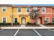 Two-story townhouses with appealing exterior finishes and landscaping at 3002 Red Ginger Rd, Kissimmee, FL 34747