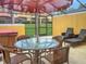 Patio with wicker furniture, hot tub, and umbrella at 3002 Red Ginger Rd, Kissimmee, FL 34747