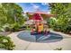 Fun playground area featuring play structures with shade, surrounded by lush landscaping and seating at 3002 Red Ginger Rd, Kissimmee, FL 34747