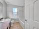 Updated bathroom with tub, single sink vanity, and tile floor at 3124 Oak Brook Ln, Eustis, FL 32736