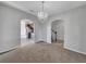 Bright dining room with carpet floors and a crystal chandelier at 3124 Oak Brook Ln, Eustis, FL 32736
