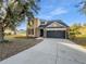 Two-story house with stone accents and a two-car garage at 3124 Oak Brook Ln, Eustis, FL 32736