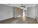 Spacious living room with wood-look flooring and a stone accent wall at 3124 Oak Brook Ln, Eustis, FL 32736